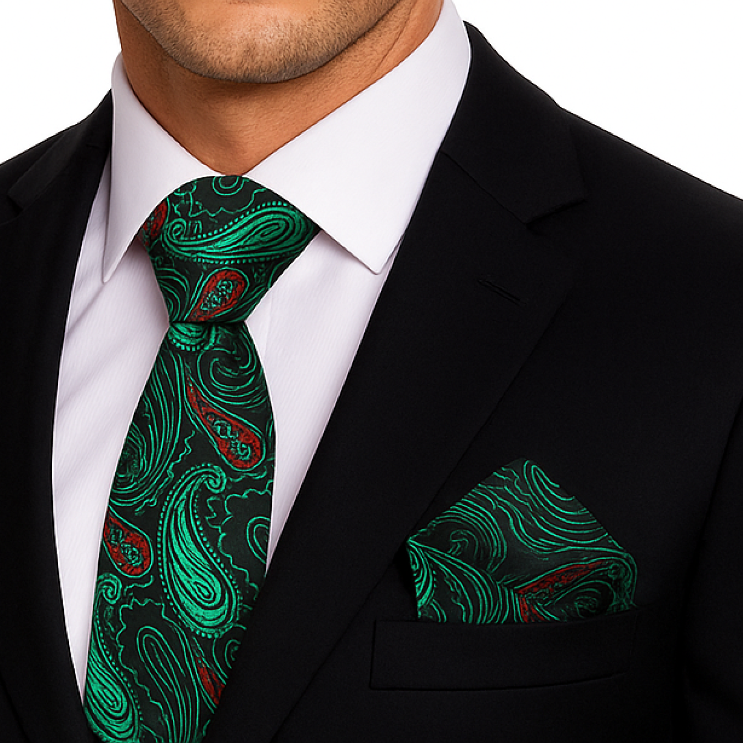 Man wearing a black suit with a green paisley tie and pocket square.