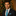 Man in Christmas setting wearing blue with red stockings tie and square