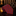 Red tie with blue polka dots on a dark surface