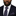 Man wearing Navy blue tie with pink polka dots and matching pocket square on a suit.