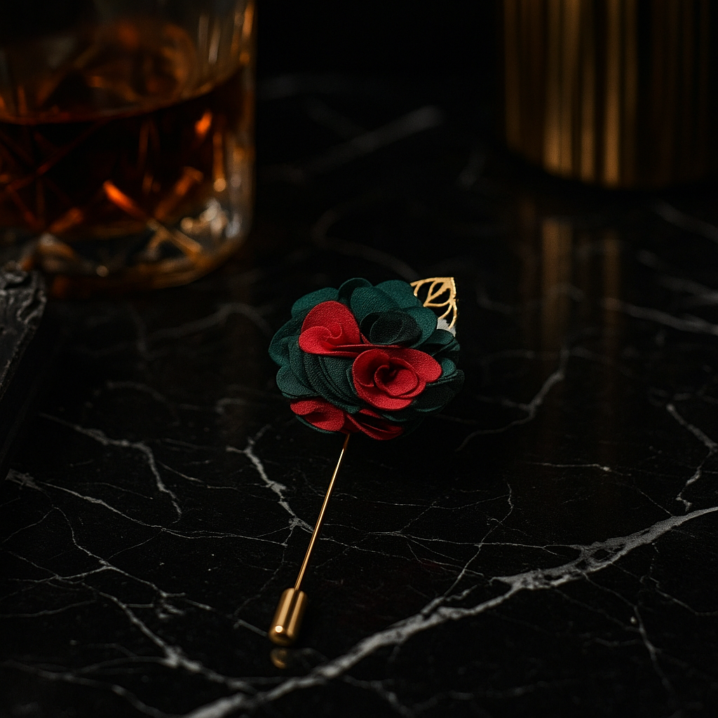 Floral lapel pin on a dark marble surface with a glass of whiskey in the background