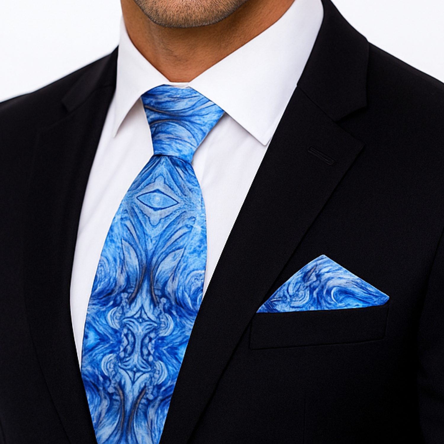 Man wearing a black suit with a blue marble-patterned tie and pocket square.