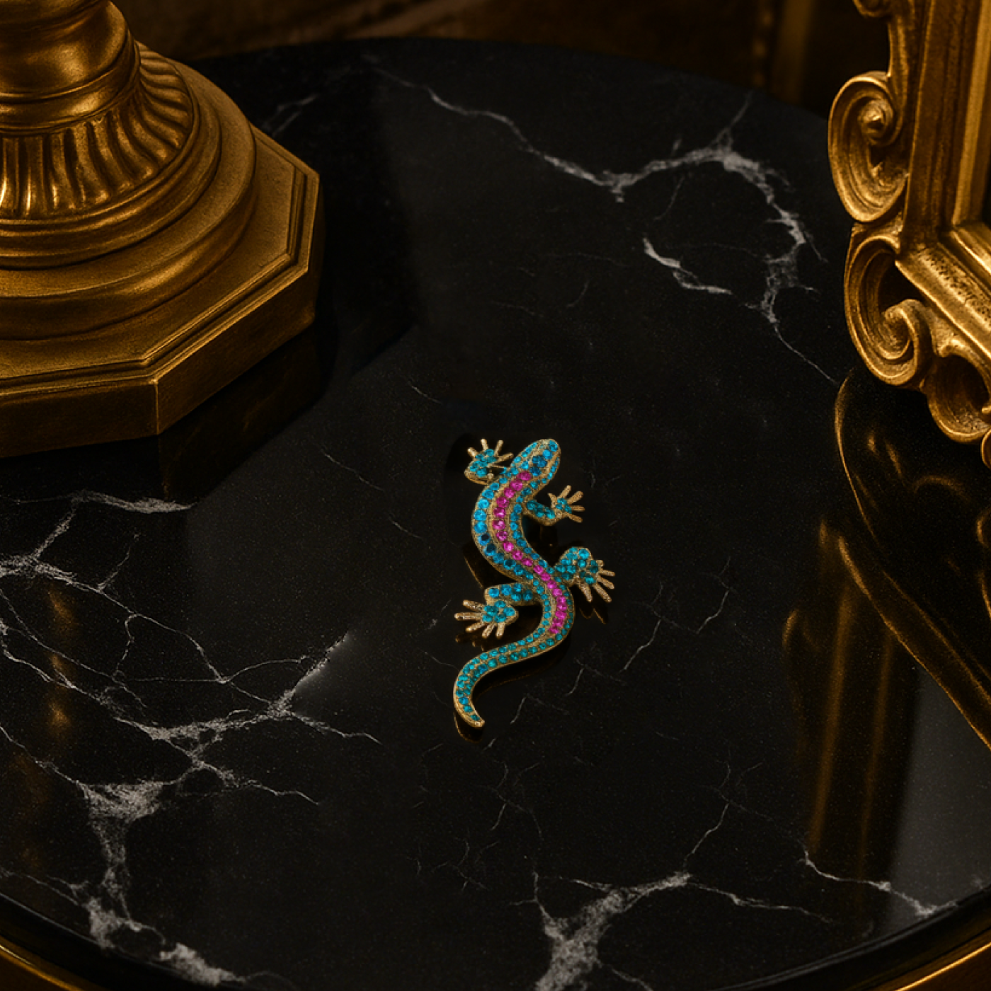 Colorful lizard-shaped brooch on a black marble surface with gold decorative elements.