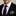 Man wearing a black suit with a purple tie and pocket square.