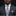 Man wearing a gray suit with a colorful floral tie and pocket square on a black background