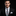 Man wearing a black suit with a Abstract Graphic Necktie Black & White with Teal and Pink Accents with Accenting Square 