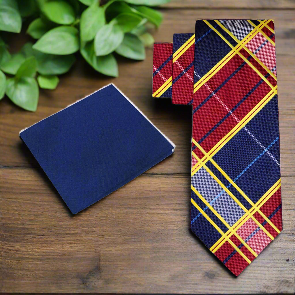 Plaid tie and matching pocket square on a wood background