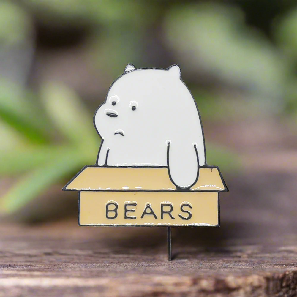 A bear in a box lapel pin