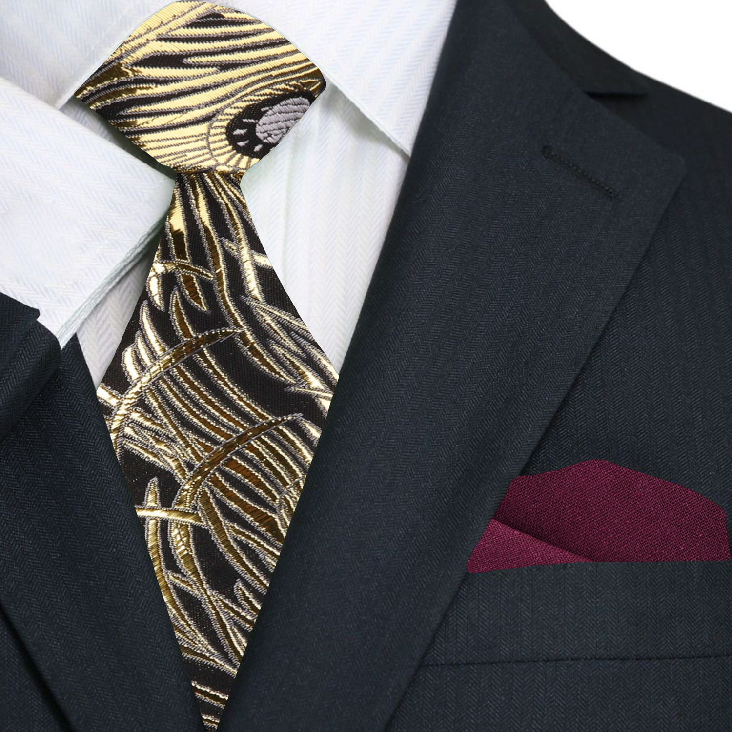 Black suit with a gold and black patterned tie and red pocket square.