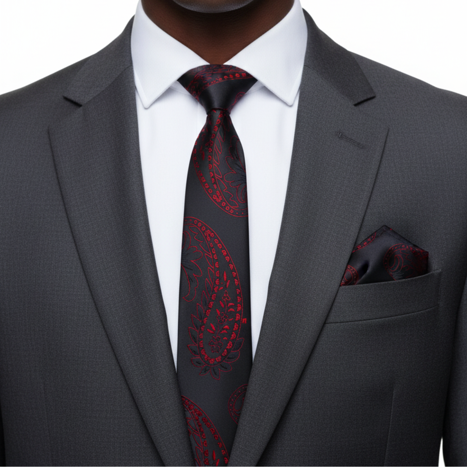 Gray suit with a red paisley tie and pocket square on a white background