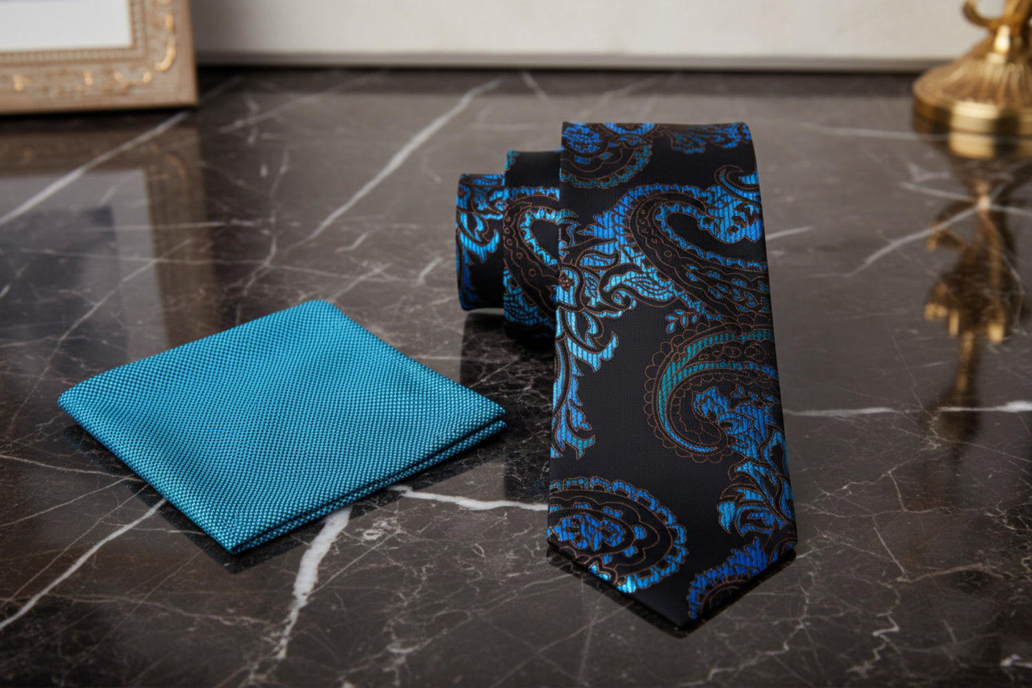 Black paisley tie with blue pattern and teal pocket square 