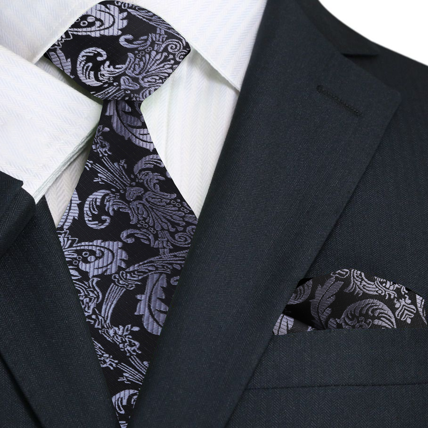 Black suit with a patterned tie and pocket square on a white background