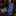 A blue patterned necktie and matching pocket square displayed on a dark marble surface, with a softly blurred boutique interior in the background.