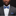 Man wearing a gray suit with a blue bow tie on a black background
