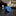 Rolled blue tie on a marble surface with a dark, ornate background