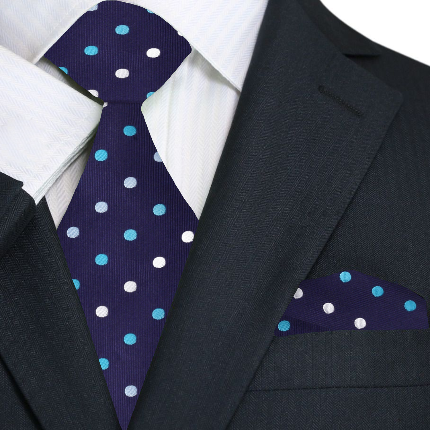 Navy blue tie with white and light blue polka dots on a suit jacket.