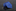 Rolled blue tie with small patterns on a dark marble surface