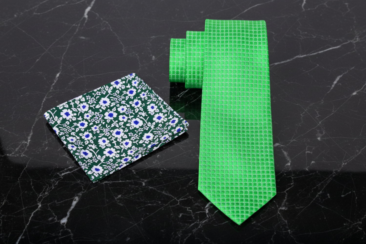 Green floral pocket square and green checkered tie on a dark background