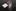 Colorful tie with abstract design next to a plain beige square on a marble surface