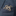A silver-toned octopus tentacle brooch pinned to the chest pocket of a textured navy blue suit jacket.