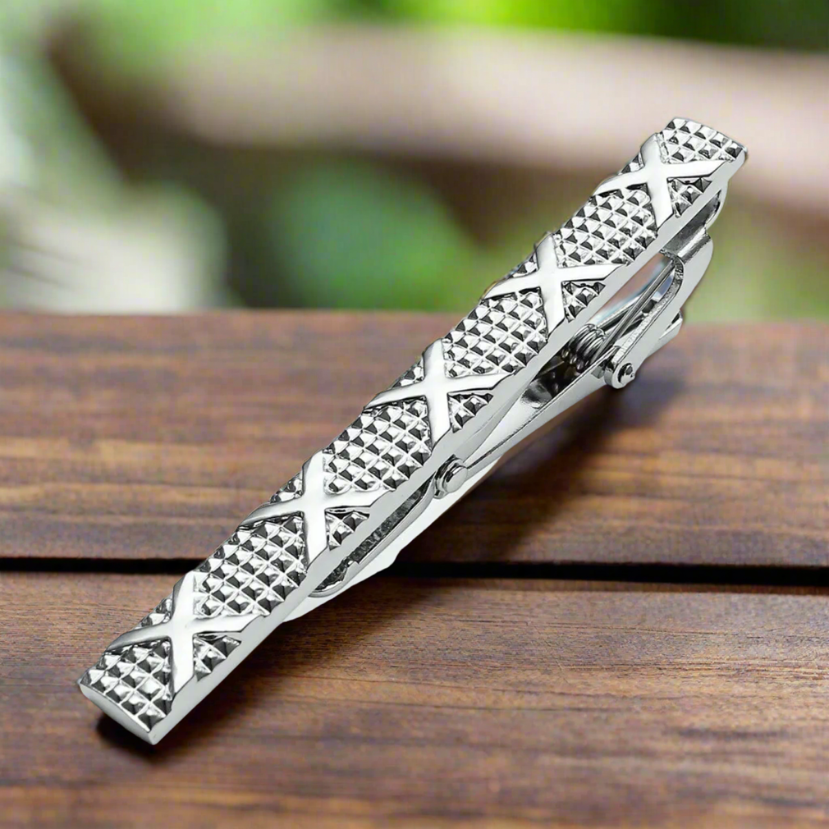 A Chrome Tie Bar with Check Texture and X's