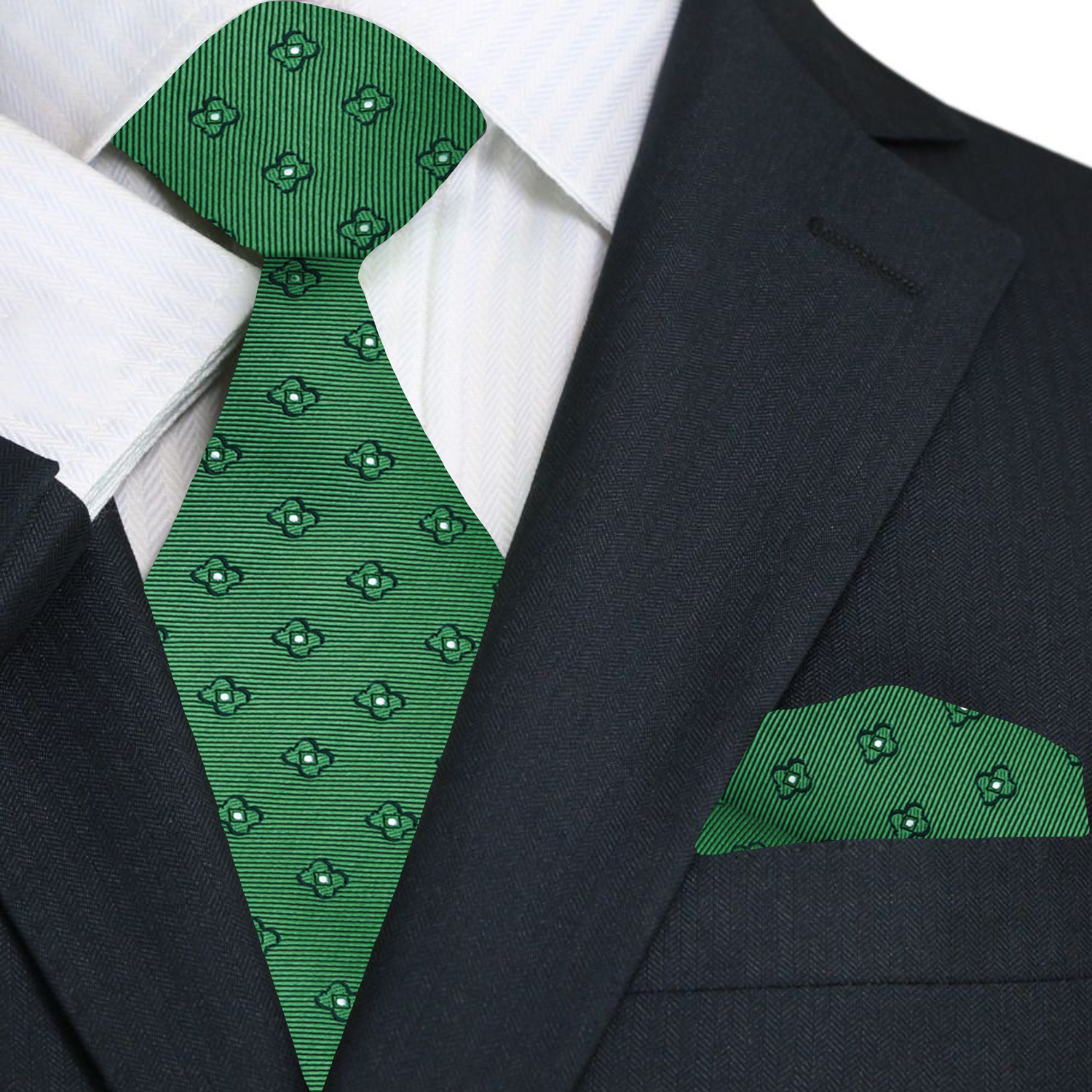 Green patterned tie and pocket square set against a black suit jacket.