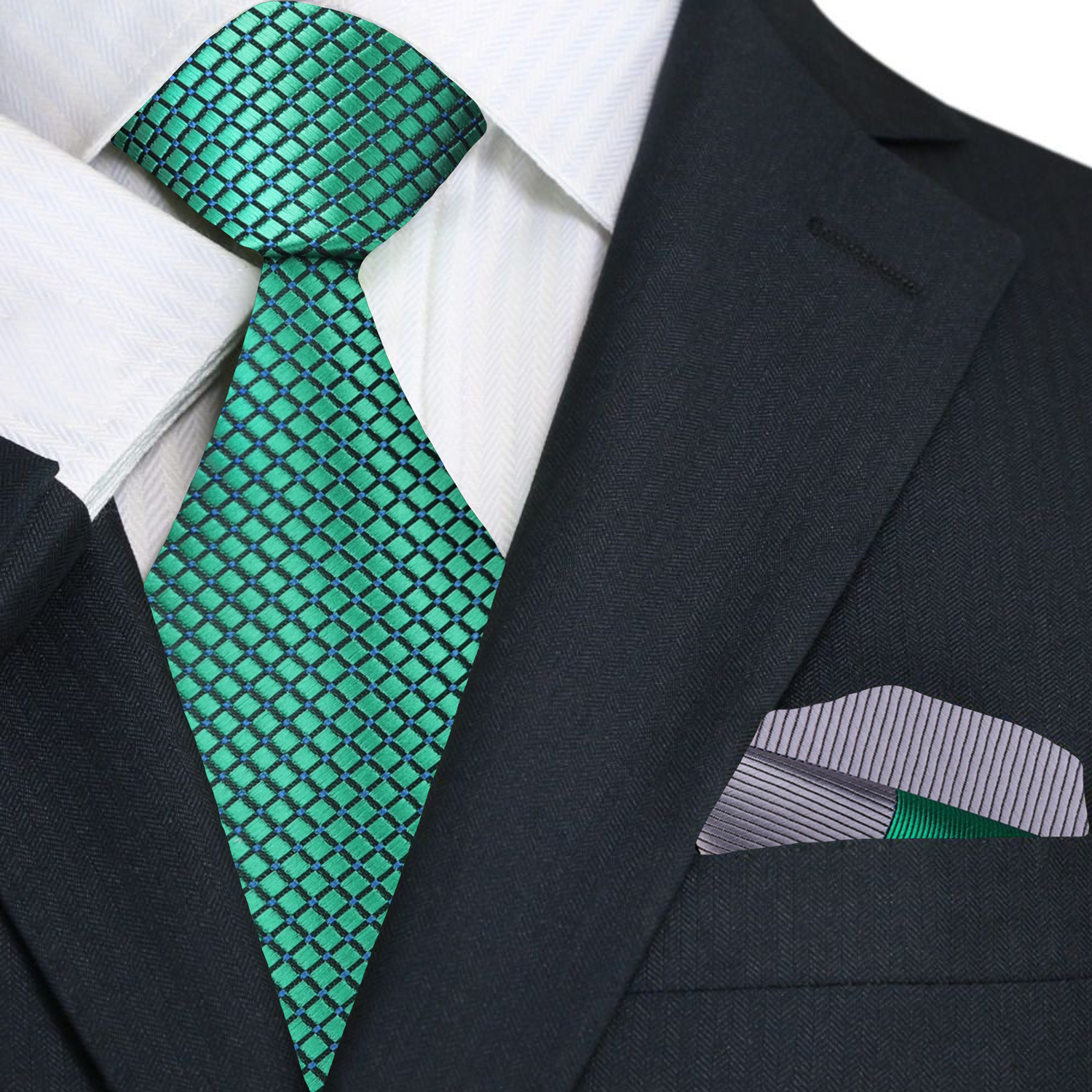 Green patterned tie and accenting grey and green pocket square on a black suit jacket.