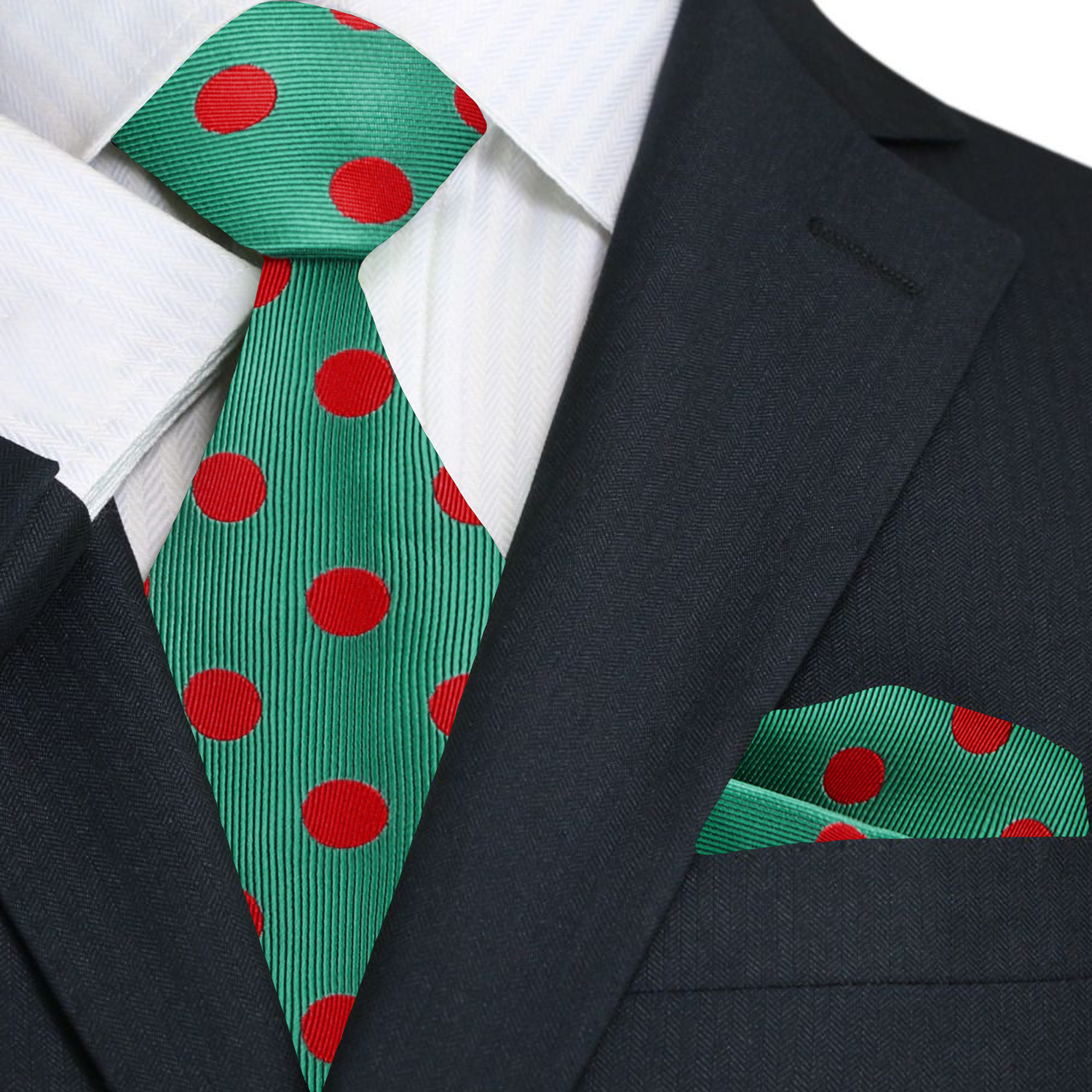 Green tie with red polka dots and matching pocket square on a suit.