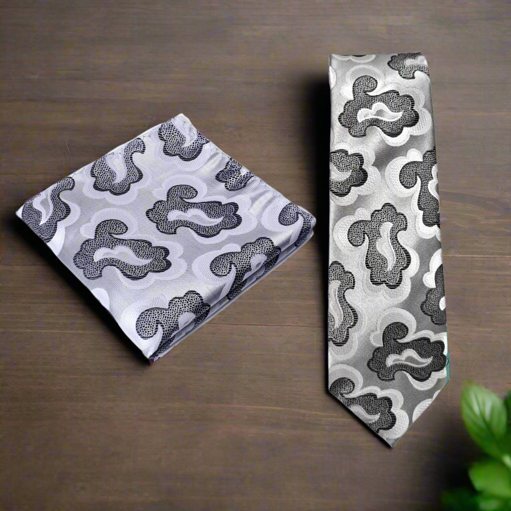Gray patterned tie and pocket square set on a white background
