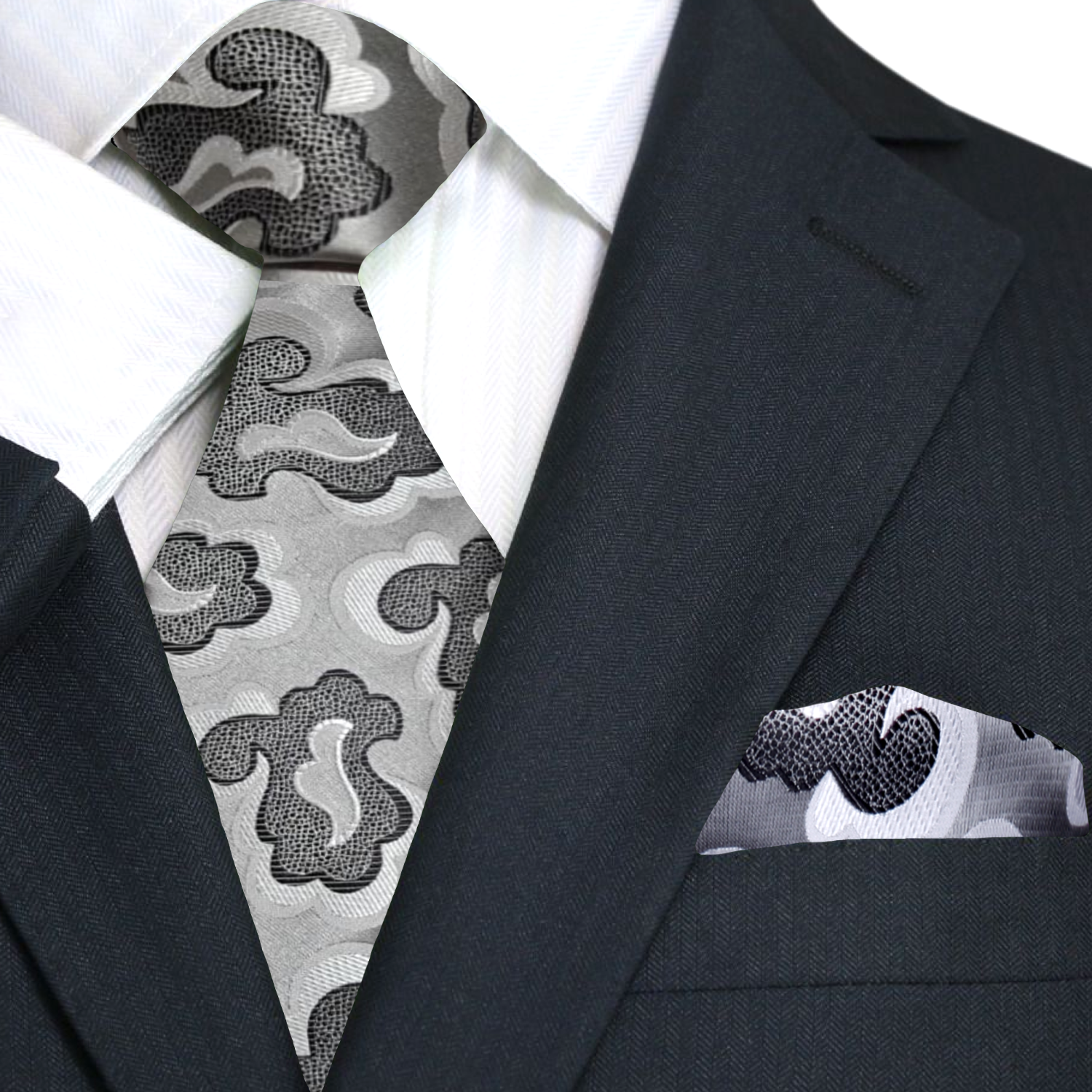 Black suit with a patterned tie and pocket square on a white background