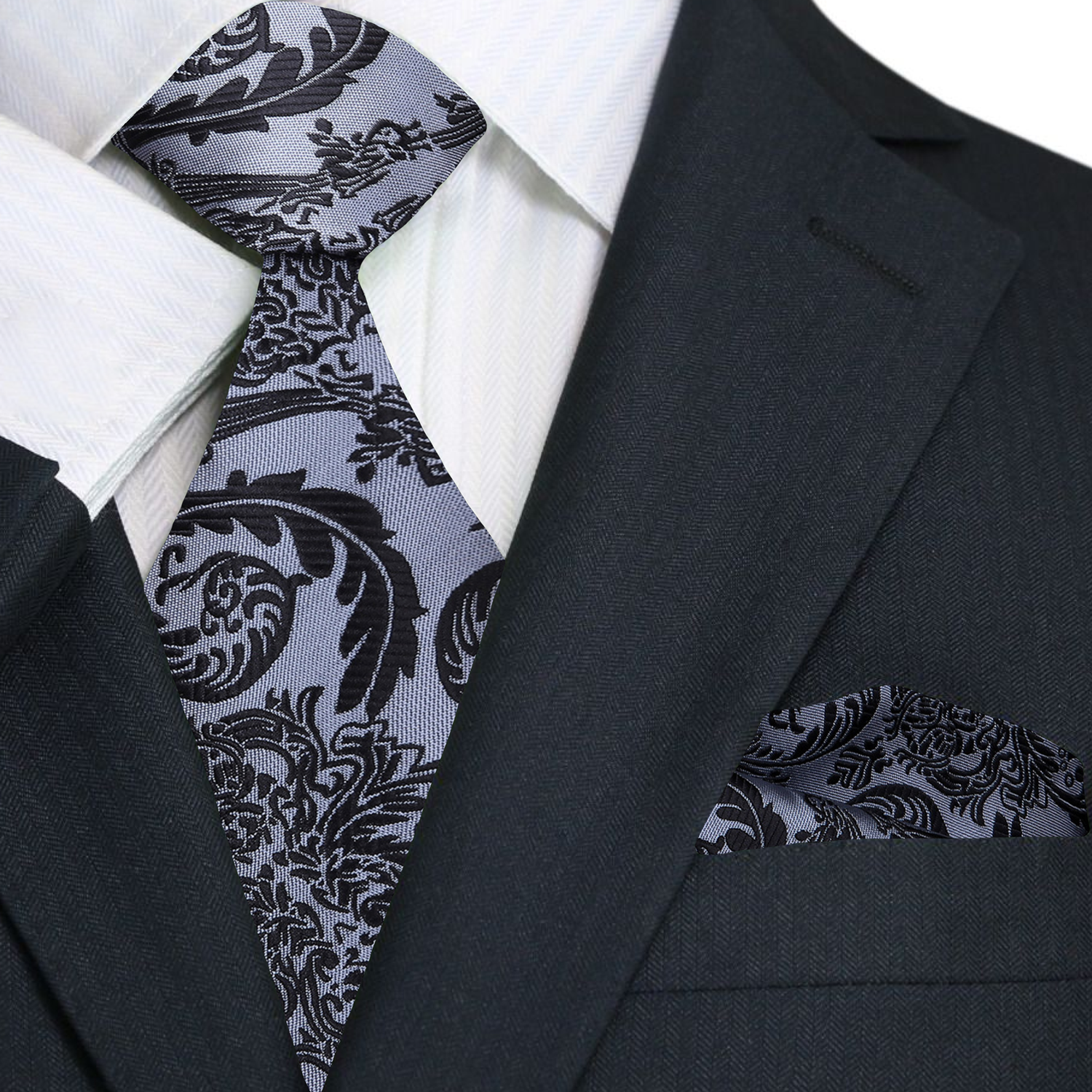 Black suit with white shirt and patterned tie and pocket square