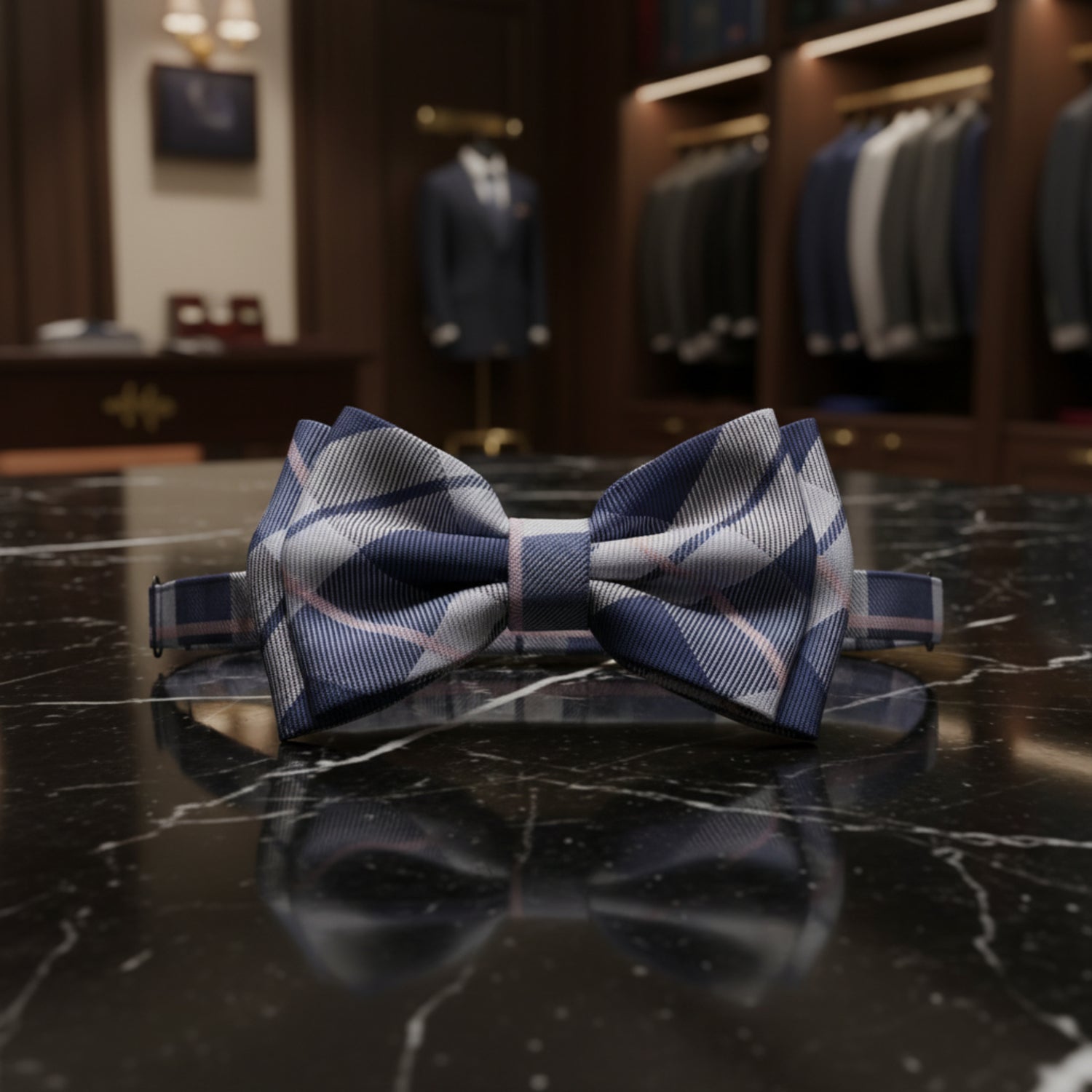 A pre-tied bow tie and matching neck strap featuring a diagonal striped plaid pattern in navy blue, gray, and white, shown against a plain white background.