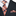 Navy suit with plaid tie and pocket square on a white background