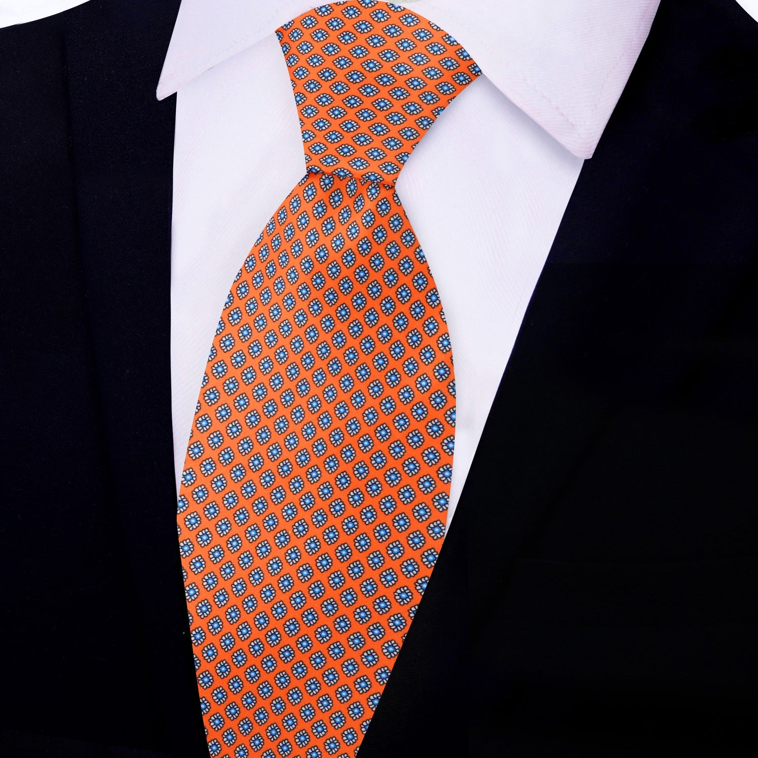 A Necktie that is sunfire coral with a small medallion pattern