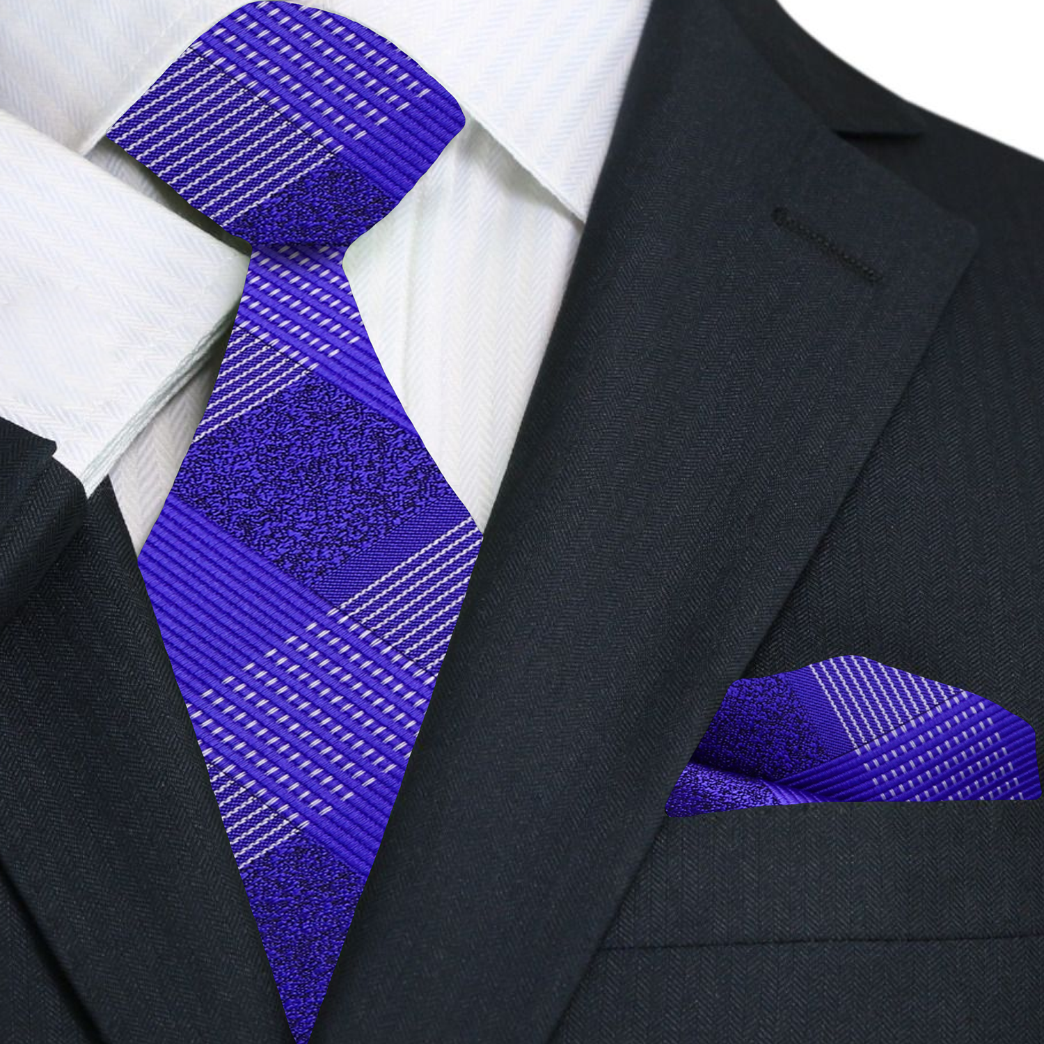 Grey suit with a purple plaid tie and pocket square