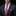 Man wearing a dark suit with a patterned tie and pocket square on a black background