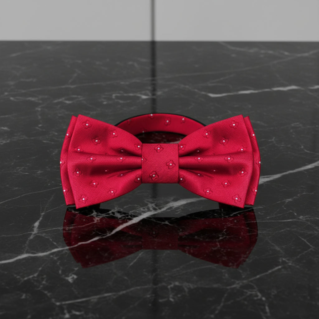 Red bow tie with white polka dots on a white background
