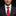 Man wearing a dark suit with a red tie and pocket square on a black background