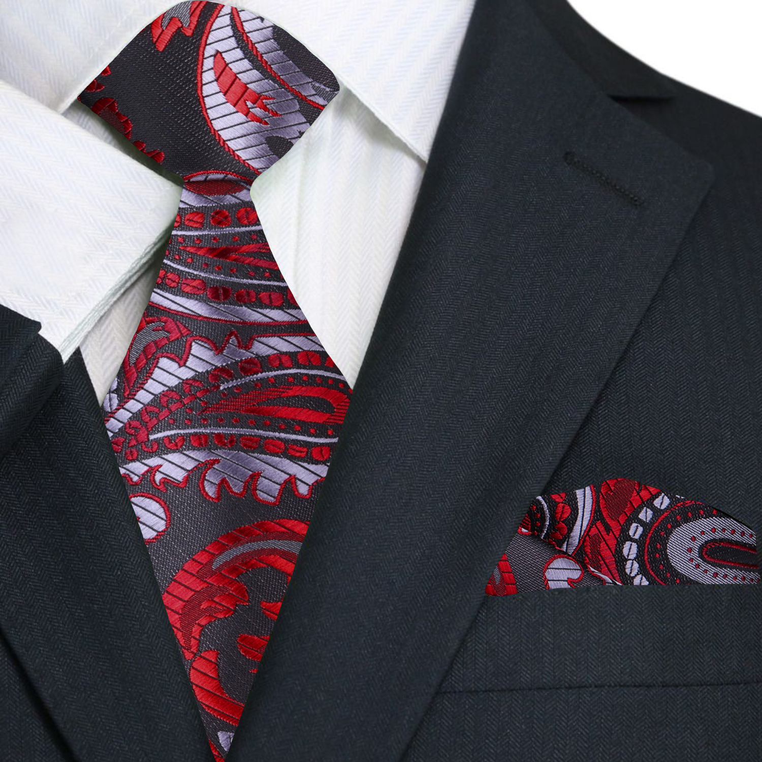 Black suit with a red and gray patterned tie and pocket square.
