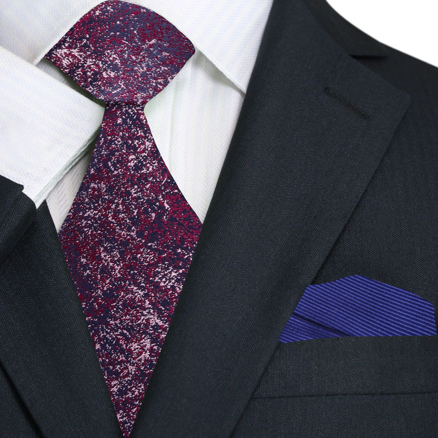 Black suit with a patterned red and blue tie and blue pocket square.