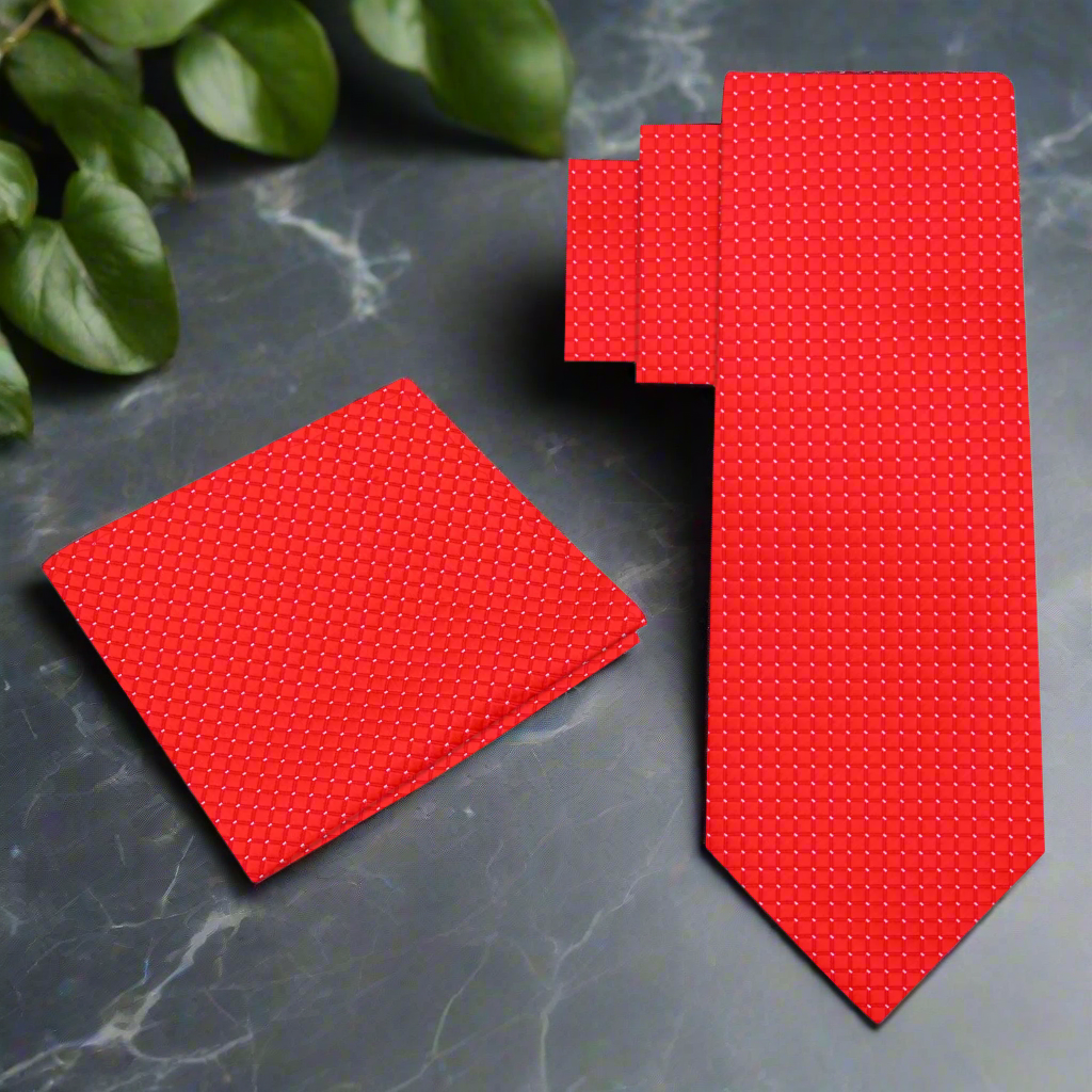 Red tie and matching pocket square with a subtle pattern 