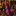 A red and navy blue holiday-themed necktie and matching pocket square set, styled on a white dress shirt and black suit jacket. 