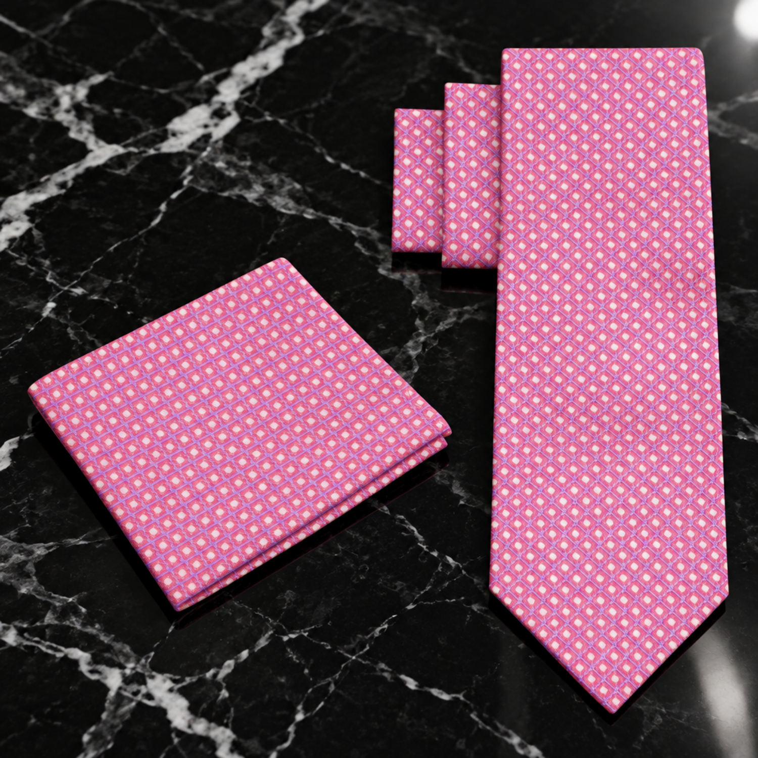 A pink necktie and matching pocket square set with a small repeating geometric diamond pattern, displayed on a clean white background.