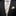 Man wearing a black suit with a striped tie and pocket square on a dark background