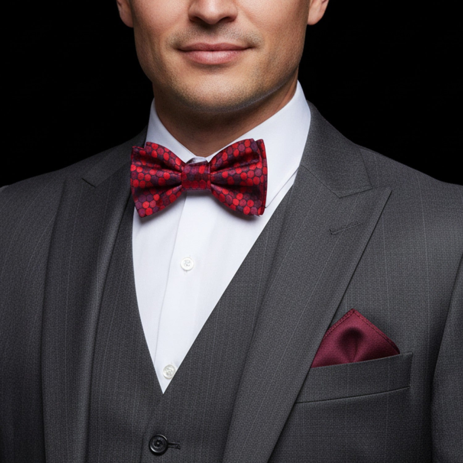 Man red patterned polka bow tie and red pocket square