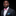 Man wearing pink paisley bow tie and accenting square with grey suit