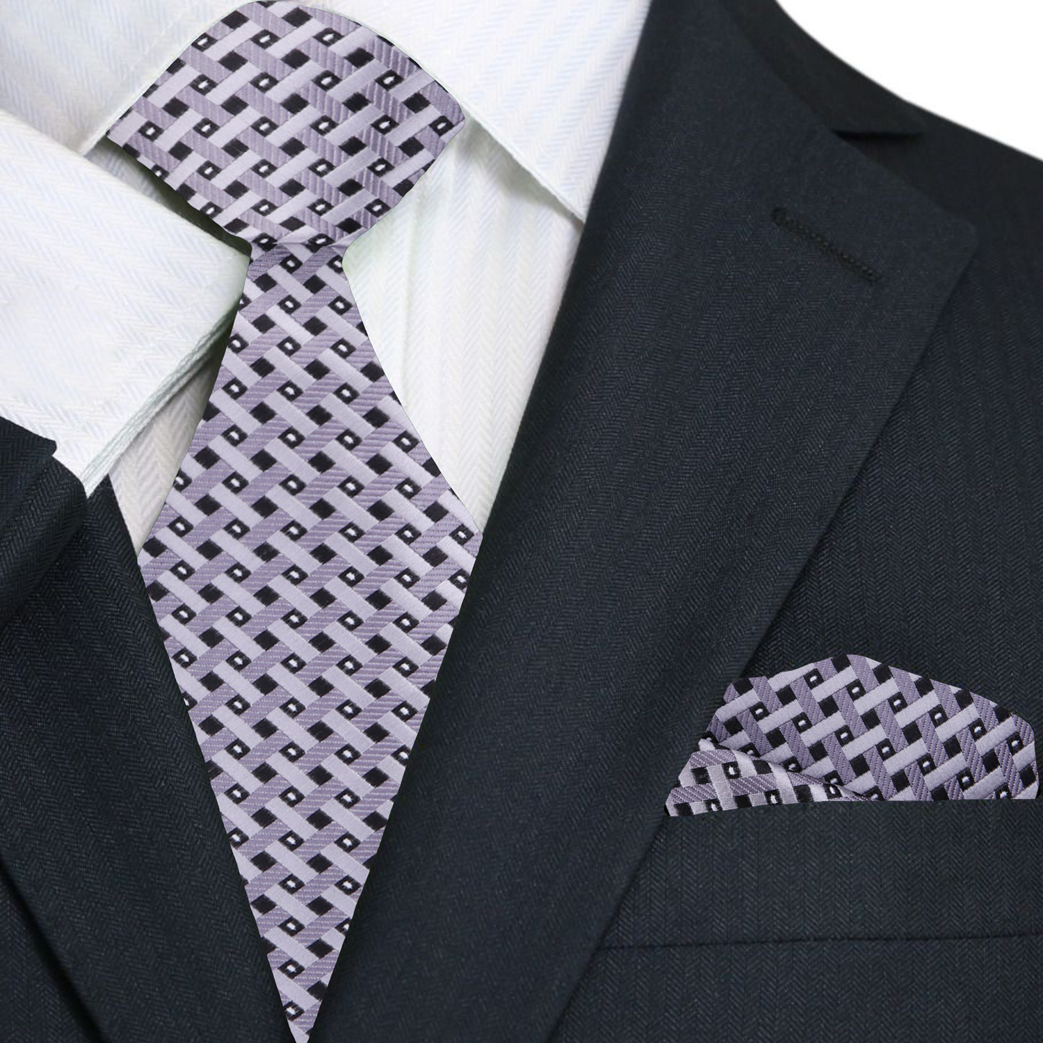 Black suit with a patterned silver geometric tie and pocket square