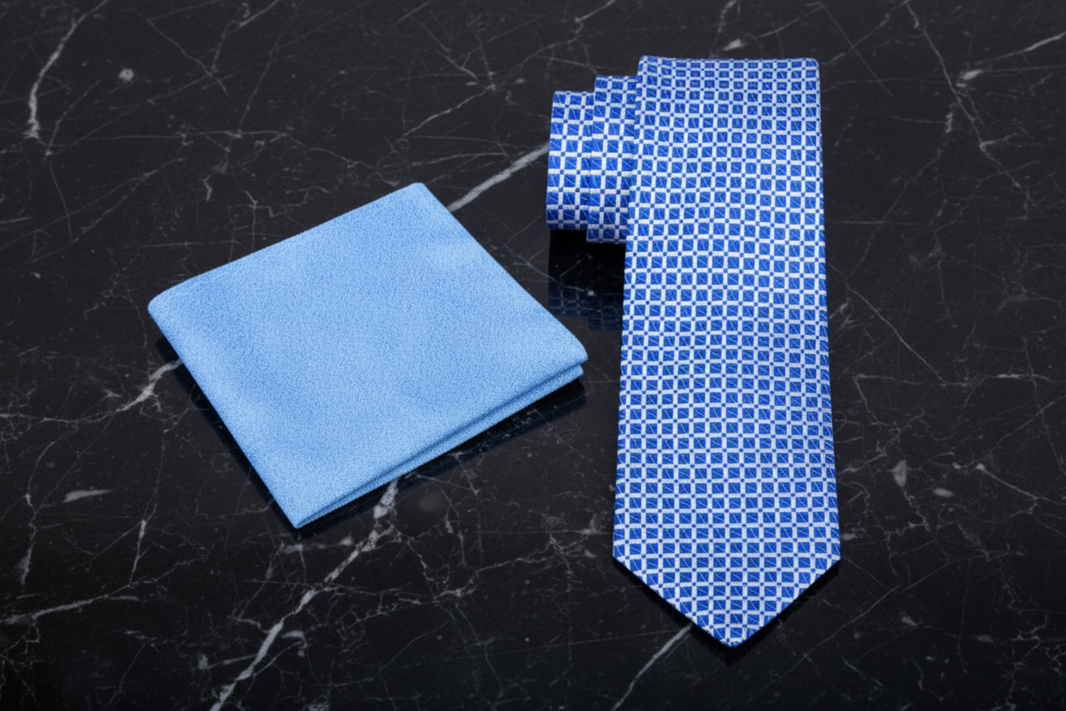 Blue geometric tie and pocket square with a geometric pattern