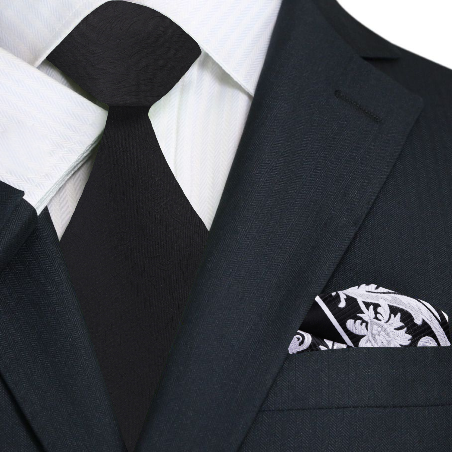 Black suit with white shirt, black tie, and patterned pocket square.