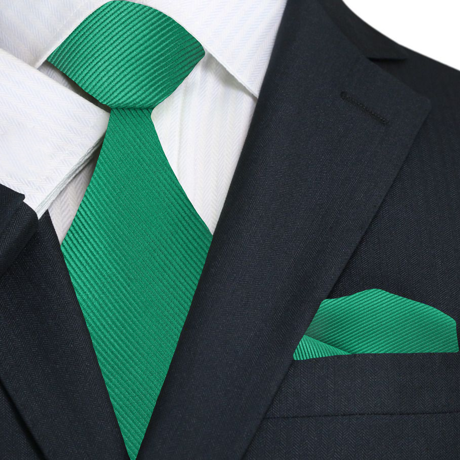 Green tie and matching pocket square with a black suit jacket